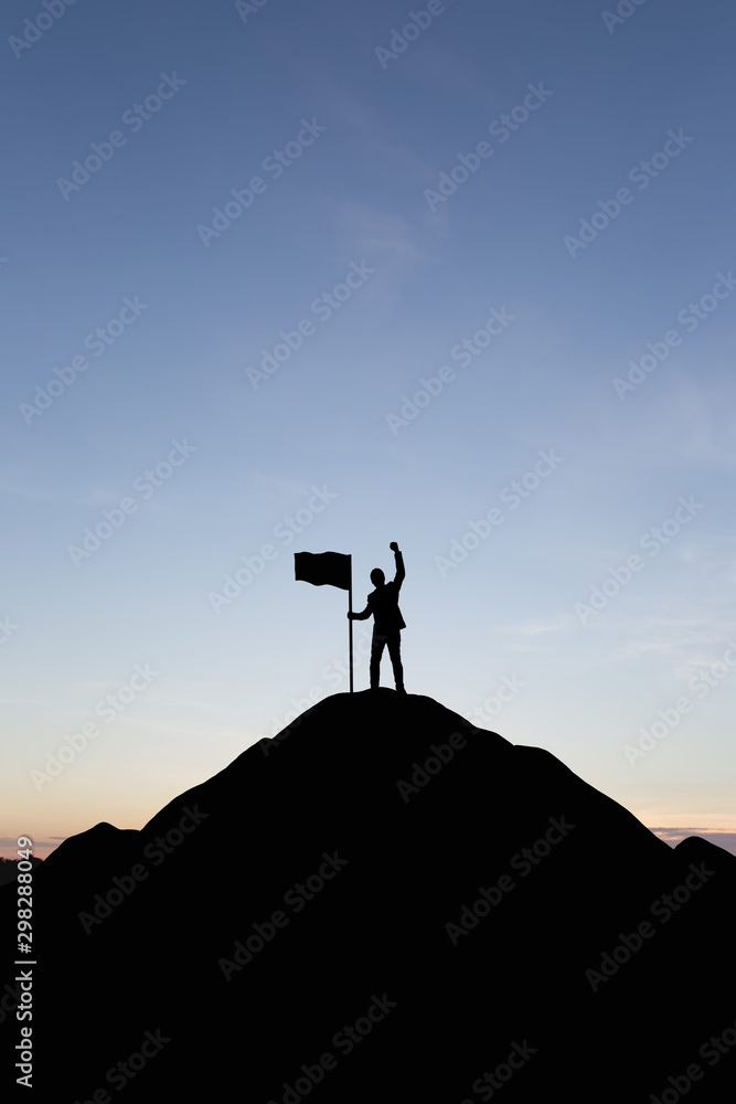 Silhouette of people and flag on top mountain, sky and sun light background. Business success and goal concept.