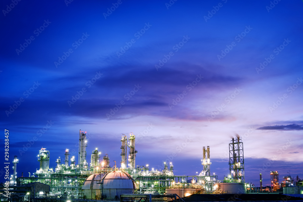 Glitter lighting of petrochemical plant on blue sky twilight background, Oil and gas refinery plant, Copy space