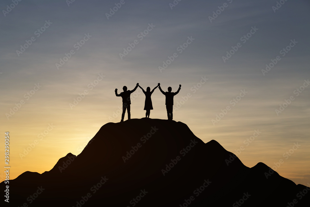 Silhouette of people are celebrating success at the top of the mountain, sky and sun light background. Team business concept.