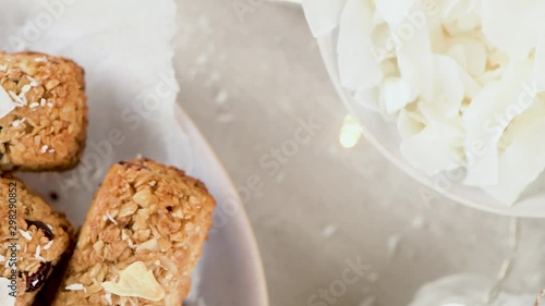 Cereal bars with almonds, coconut and cramberries on a Christmas season table decorated with lights and stars. photo