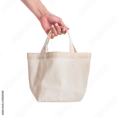 Tote bag canvas white cotton fabric cloth for eco shoulder shopping sack mockup blank template isolated on white background (clipping path) with woman’s hand handling handle straps