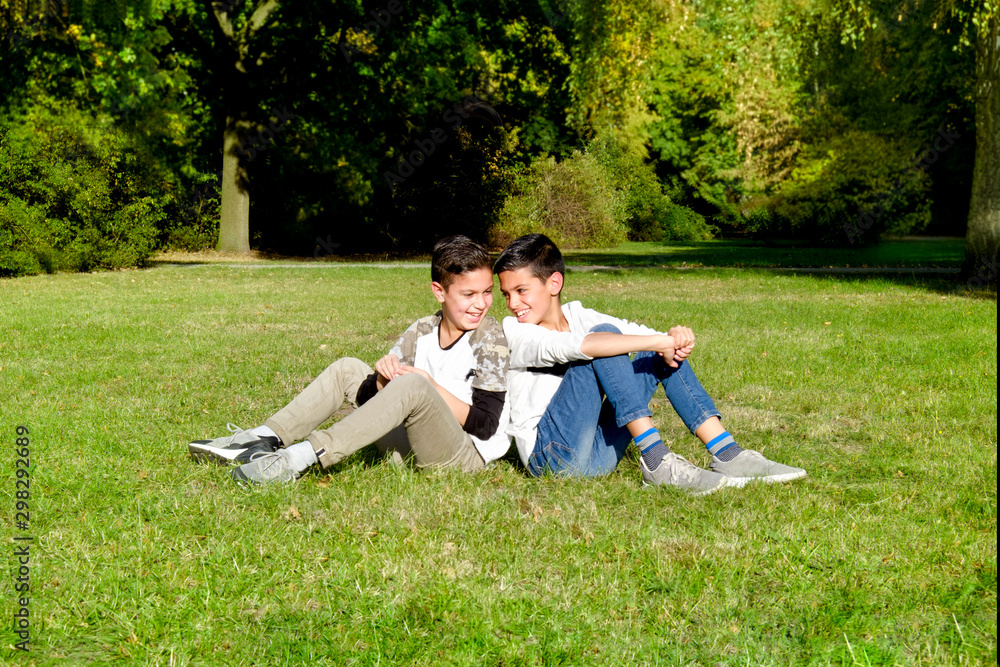 mother and teenage children in walking the park mother and teenage children in walking the park