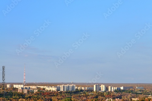 Telecommunication tower with cellular network antenna on city background