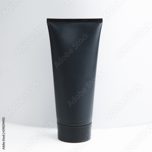 Jar for cosmetics without background. Black matte tube on white background.