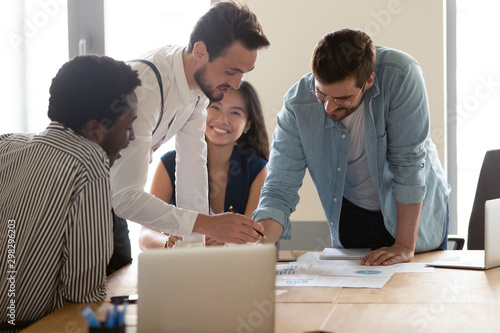 Friendly diverse employees discussing marketing plan at meeting