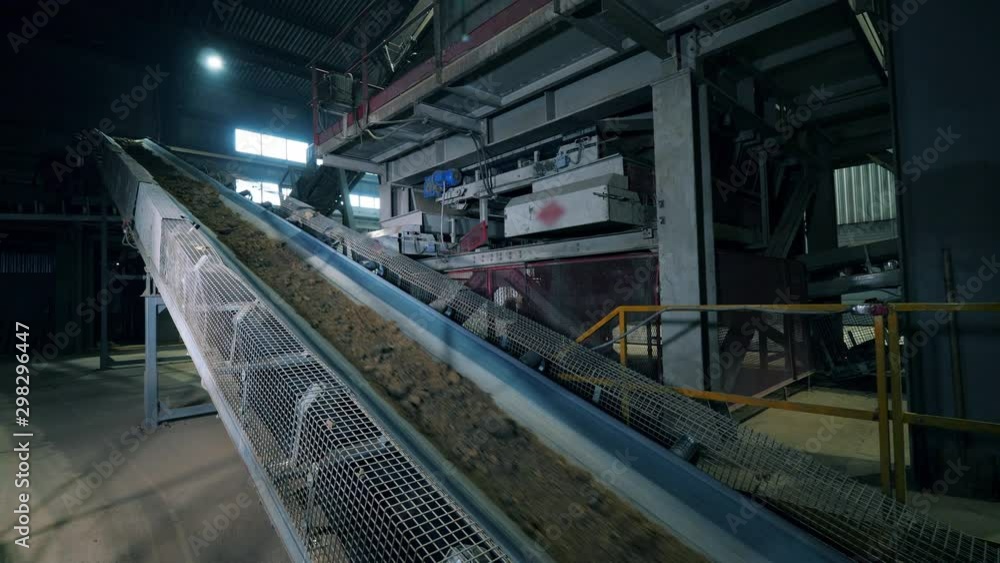 Crushed stone moving on a factory conveyor. Crushed stone moving on a factory conveyor.
