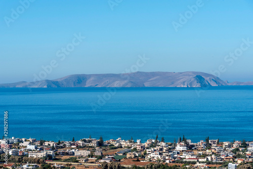Gouves, Heraklion, Crete, Greece. October 2019. An overview of the town of Gouves towards Dia Island just of the coast and in the Sea of Crete. photo