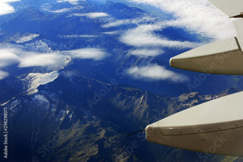 Airplane flies over the mountains