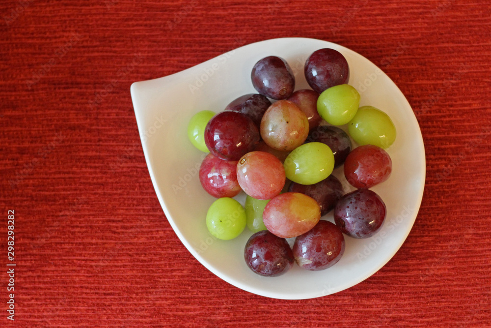 Some grapes and muscats on white dish Some grapes and muscats on white dish
