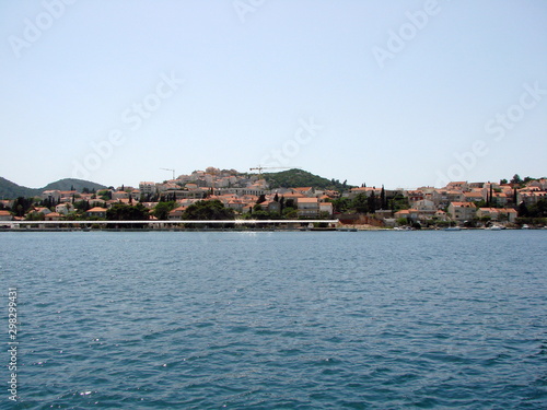View from the seaport on the coastal buildings of Dubrovnik on the opposite side of the bay against a background of blue sea and clear sky.