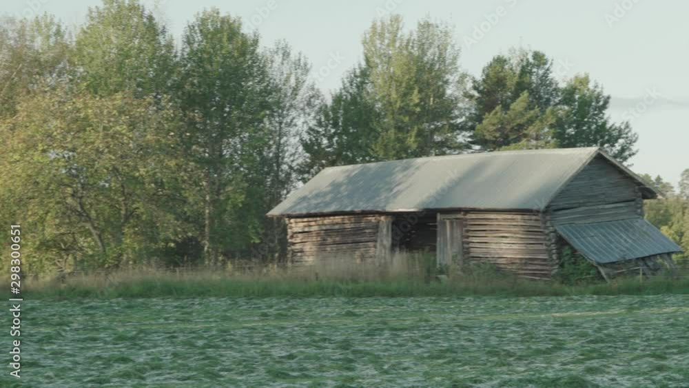 Old wooden house in fields, next to forest. Scandinavia. Old wooden house in fields, next to forest. Scandinavia.