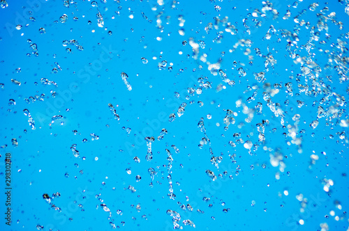 Blue water drops on blue sky background