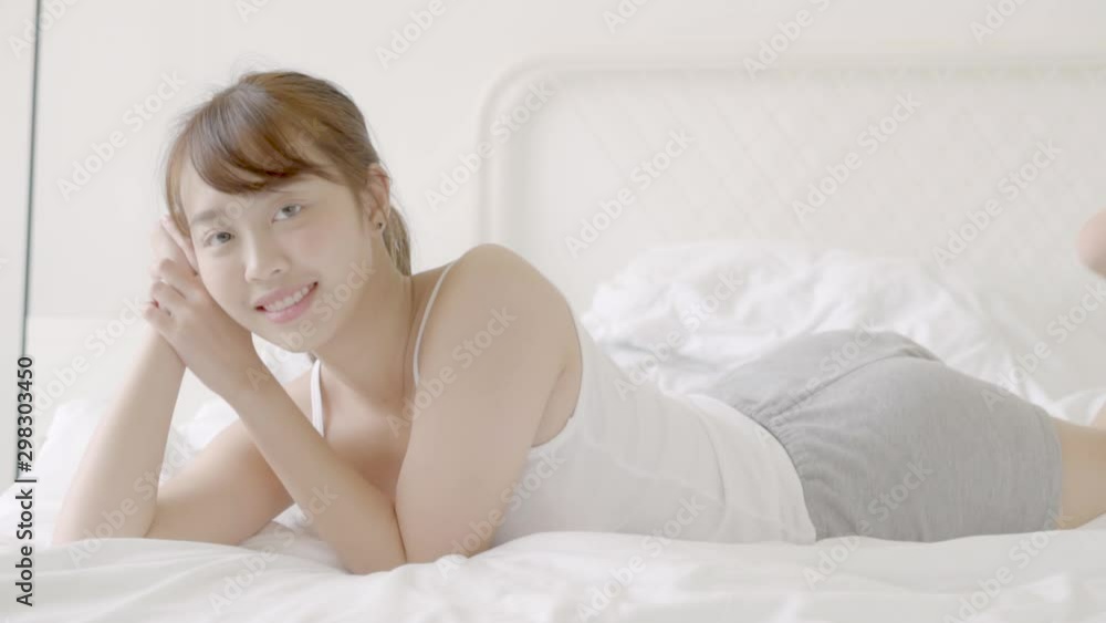 Beautiful portrait young asian woman sitting taking a selfie with smart mobile phone on bedroom in the morning at home, girl is photographing happy and smile with fun, lifestyle concept. Beautiful portrait young asian woman sitting taking a selfie with smart mobile phone on bedroom in the morning at home, girl is photographing happy and smile with fun, lifestyle concept.
