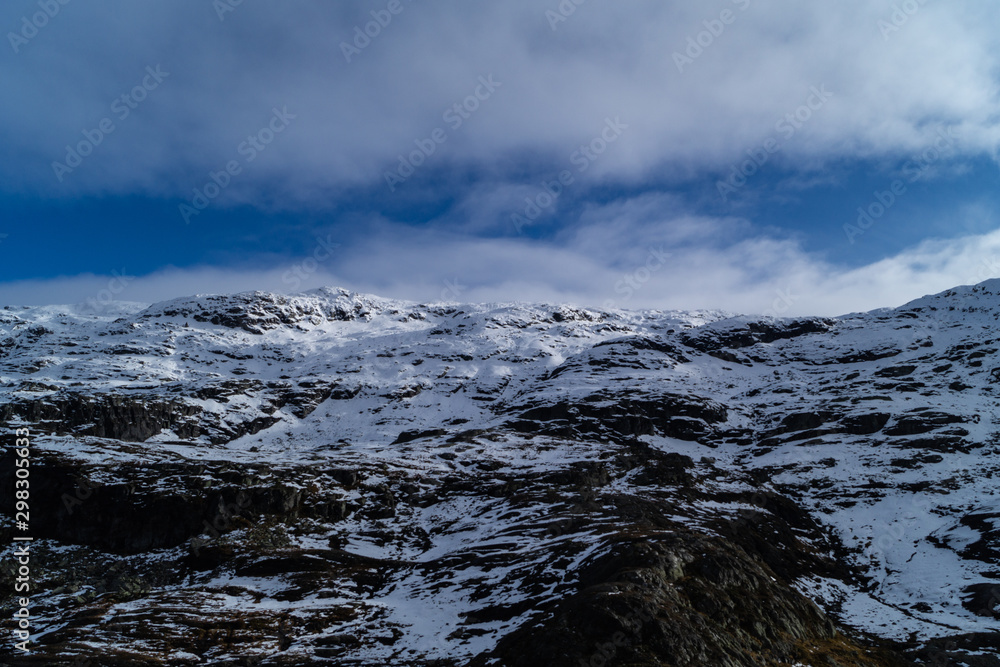 Mountains tops with snow and clouds