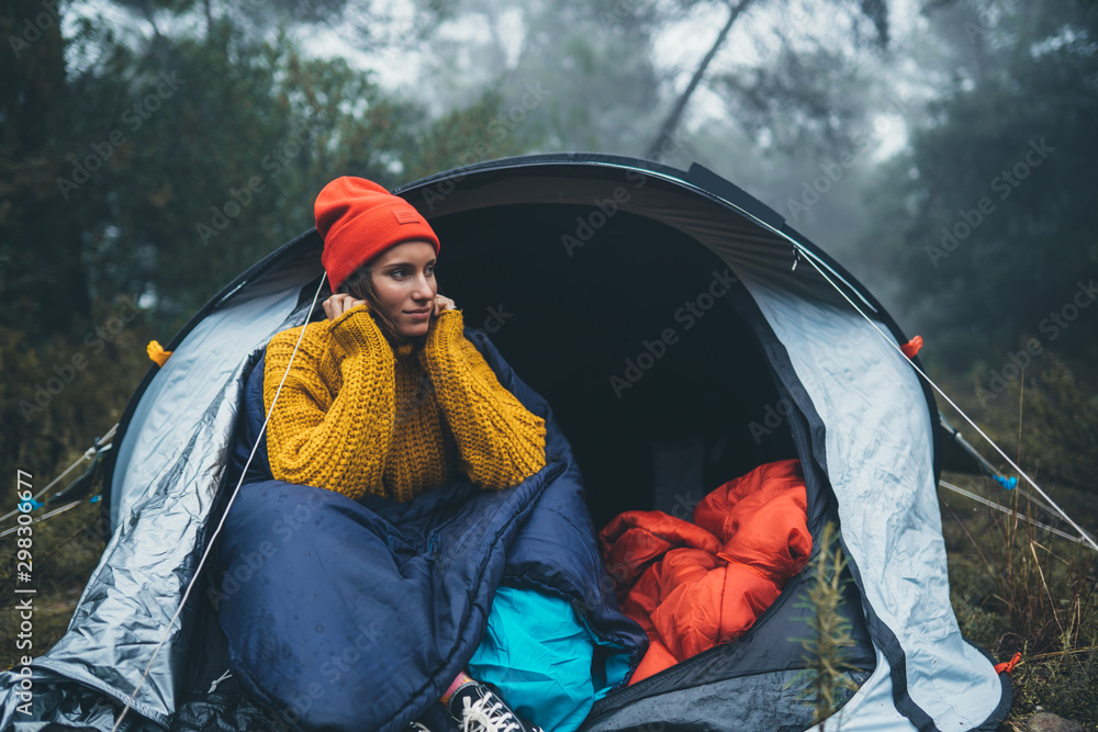 tourist traveler ralaxing in camp tent in foggy rain forest, closeup happy hiker woman enjoy mist nature trip, green trekking tourism, rest vacation concept camping holiday tourist traveler ralaxing in camp tent in foggy rain forest, closeup happy hiker woman enjoy mist nature trip, green trekking tourism, rest vacation concept camping holiday