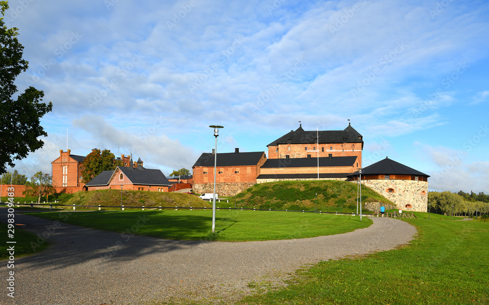 Medieval fortress on coast of picturesque lake Vanajavesi in Hameenlinna, Suomi. Autumn