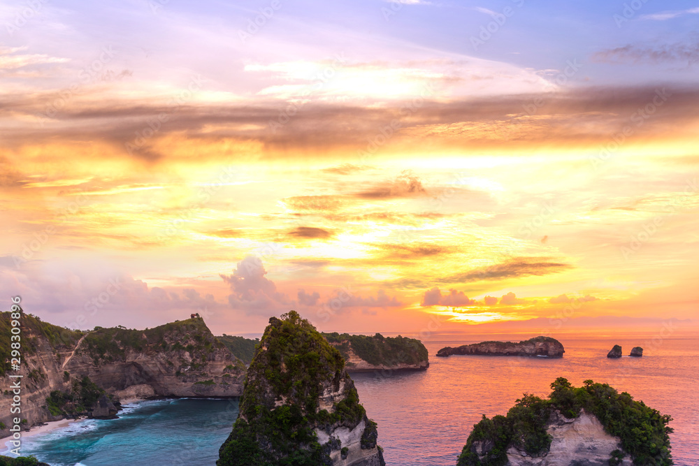Early morning sunrise with Vew of cliff Nusa Penida Island, Bali, Indonesia. Azure beach, rocky mountains in ocean