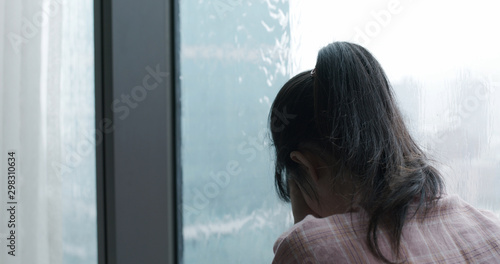 woman cry near by window