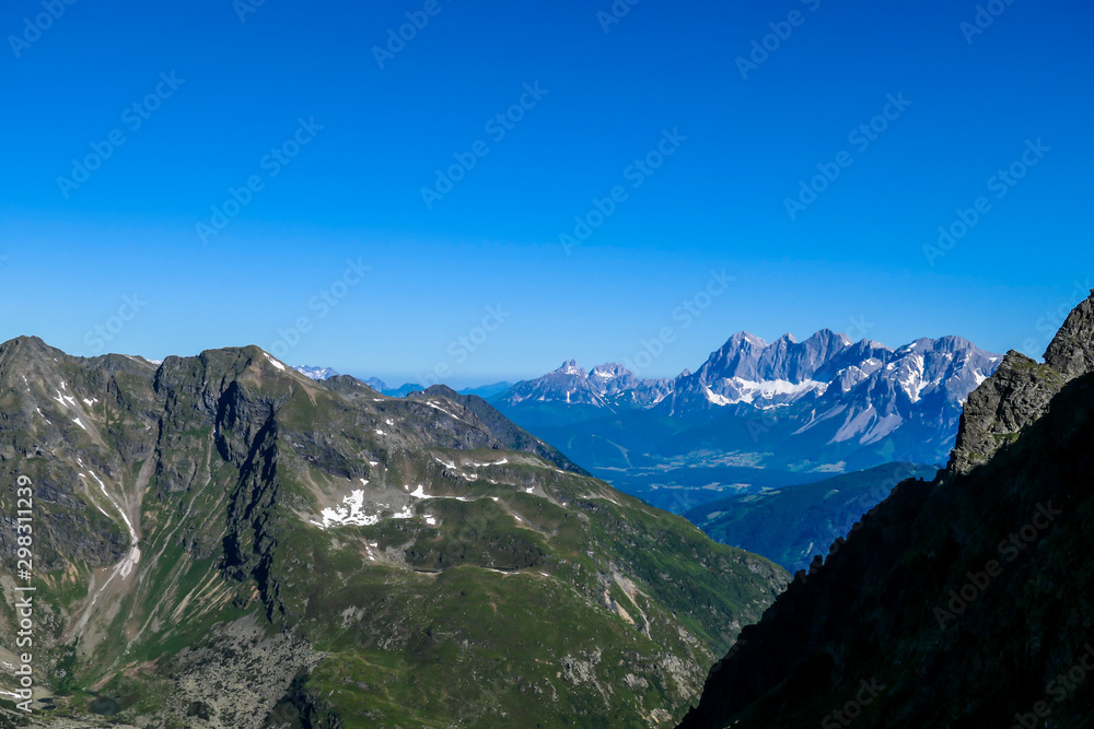 Massive mountain range of Schladming Alps, Austria. The slopes of Alps are steep, partially overgrown with green bushes. Dangerous mountain climbing.Clear and beautiful day. Endless mountain ranges, Massive mountain range of Schladming Alps, Austria. The slopes of Alps are steep, partially overgrown with green bushes. Dangerous mountain climbing.Clear and beautiful day. Endless mountain ranges,