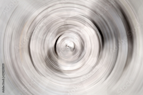 Blurred radial motion gradient white gray background. Circular brushed texture