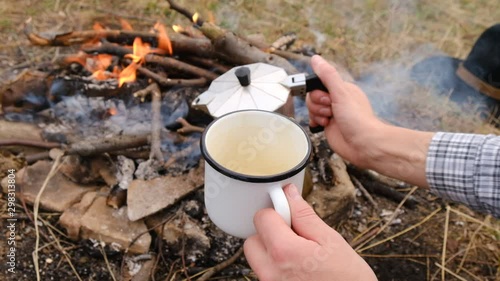 Wallpaper Mural POV of  female hands pours hot coffee from coffeemaker in white cup with overlook campfire, beautiful and inspiring camp location for outdoor vibes living lifestyle Torontodigital.ca