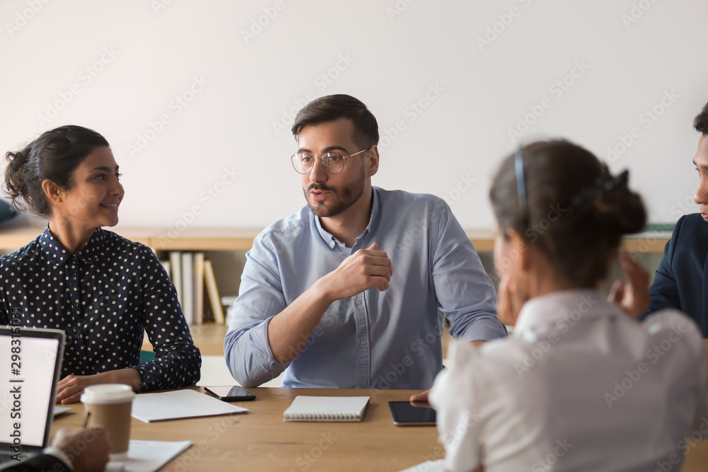 Young multiracial team working together with boss at office Young multiracial team working together with boss at office