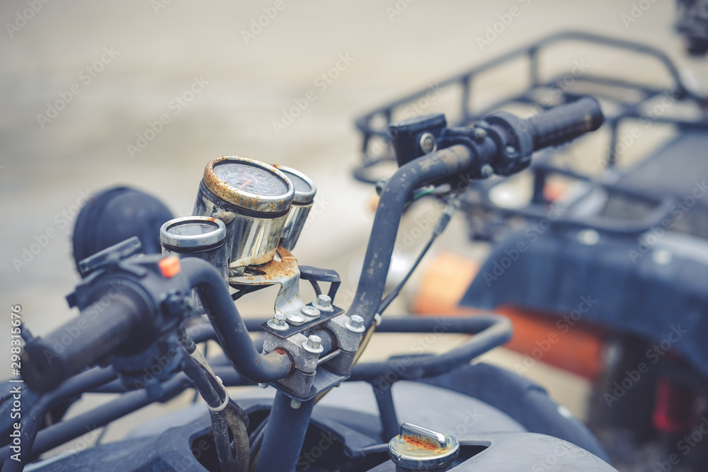 ATV racing car. A closed up of ATV racing car handle bar with soft focus on the rusty dial. ATV racing car. A closed up of ATV racing car handle bar with soft focus on the rusty dial.