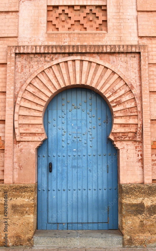 Beautiful Light Blue Door in a Warm Golden Red Brick Archway from Cadiz, Spain Beautiful Light Blue Door in a Warm Golden Red Brick Archway from Cadiz, Spain