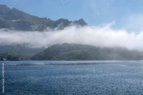 fog bank over fish farm in fjord near Fiskebol, Norway photo