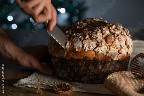 Panettone, tipico dolce natalizio italiano con mandorle, cioccolato e zucchero photo