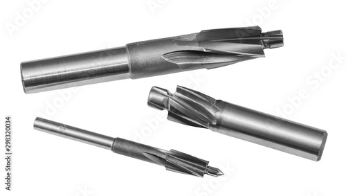 Three steel cylindrical counterbores isolated on white background. Sharp cutting tools set for drilling counterbored coaxial holes. Detail of spiral fluted cutters. Metal equipment for chip machining.