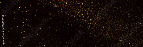 background of abstract glitter lights. gold and black. de focused. banner