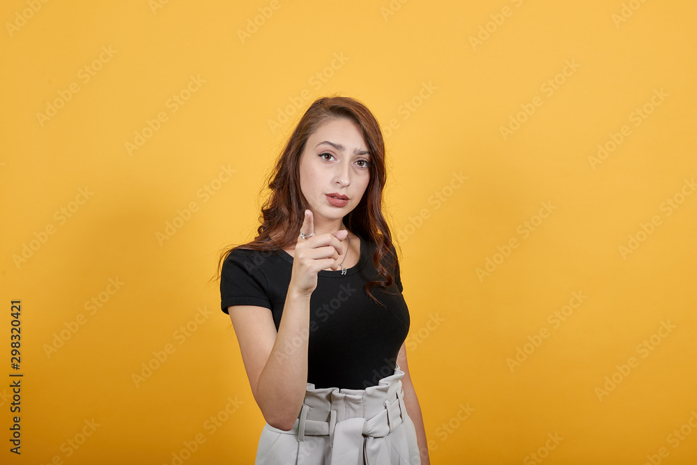 Girl pointing as she has some business with that person. She looks suspicious as it is not a good indication for her because she has some doubts that's why she wants that particular person. Girl pointing as she has some business with that person. She looks suspicious as it is not a good indication for her because she has some doubts that's why she wants that particular person.