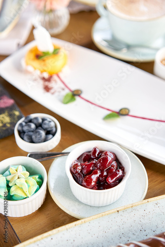 Wallpaper Mural Breakfast in the cafe, morning coffee. Cappuccino and lots of desserts on the table. Eclair, mousse cake, chocolate truffle and cheesecake, Torontodigital.ca