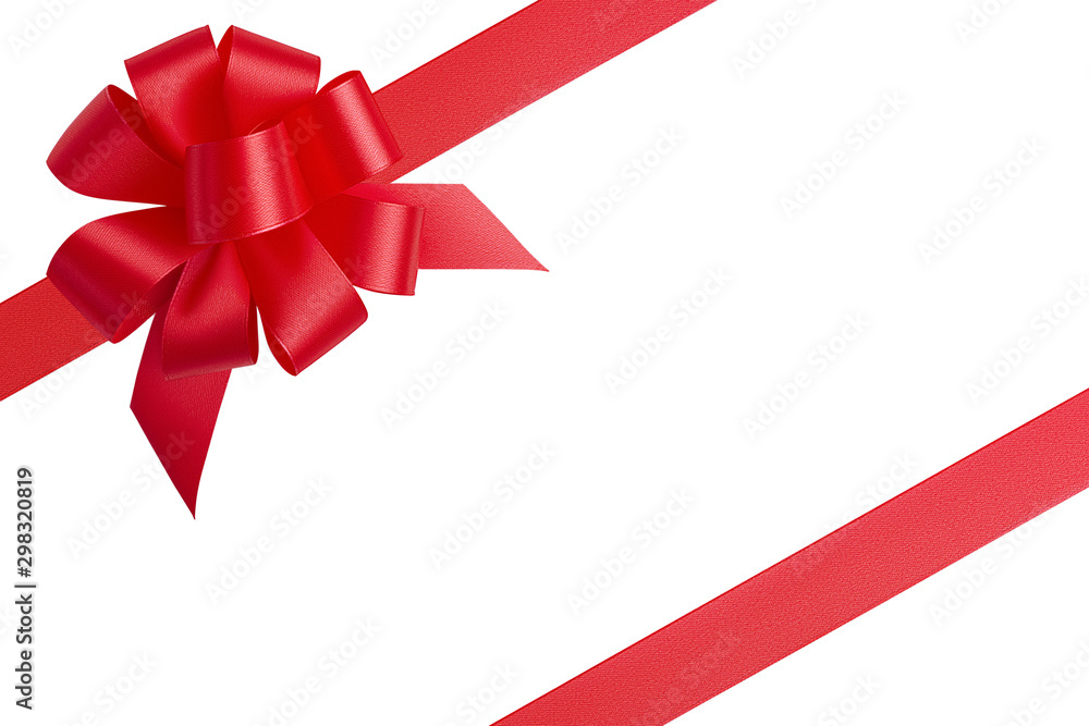 Top view creative composition of two red satin shiny ribbons located diagonally in the corners of the picture and a large bright unusual beautiful bow with empty space isolated on white background Top view creative composition of two red satin shiny ribbons located diagonally in the corners of the picture and a large bright unusual beautiful bow with empty space isolated on white background
