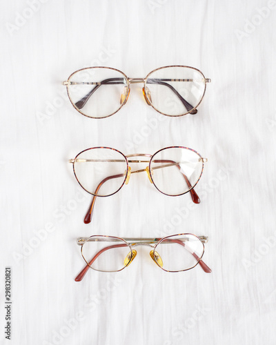 Set of retro eyeglasses isolated on white linen background. Flat lay. Top view. Copy space