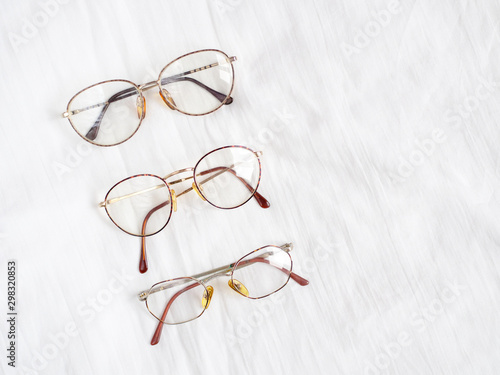 Set of retro eyeglasses isolated on white linen background. Flat lay. Top view. Copy space