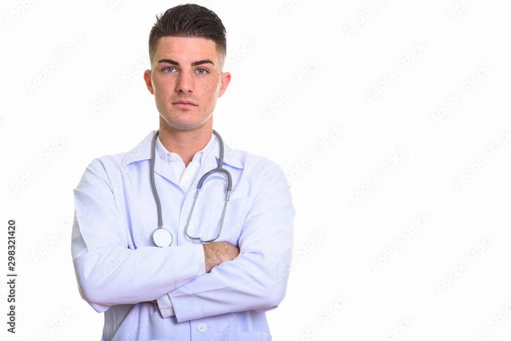 Studio shot of young handsome man doctor with arms crossed Studio shot of young handsome man doctor with arms crossed