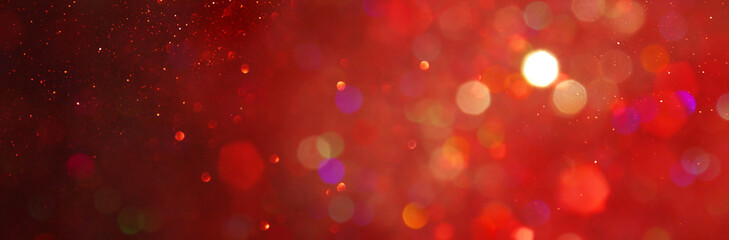 background of abstract red, gold and black glitter lights. defocused. banner