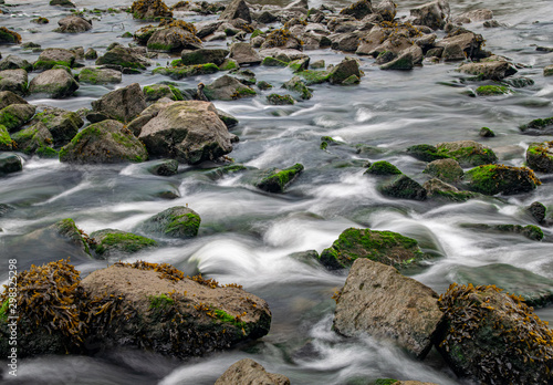 Fototapeta Naklejka Na Ścianę i Meble -  Long exposure of River Meavy water flowing over rocks at Lopwell Weir, Plymouth, Devon
