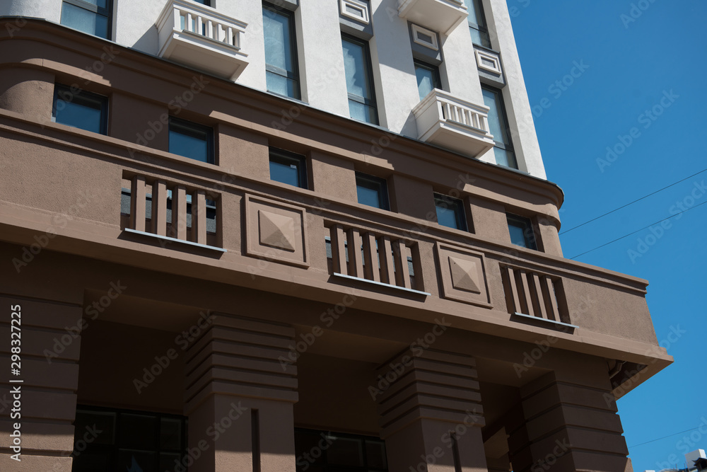 Part of a modern building against the blue sky. Part of a modern building against the blue sky.