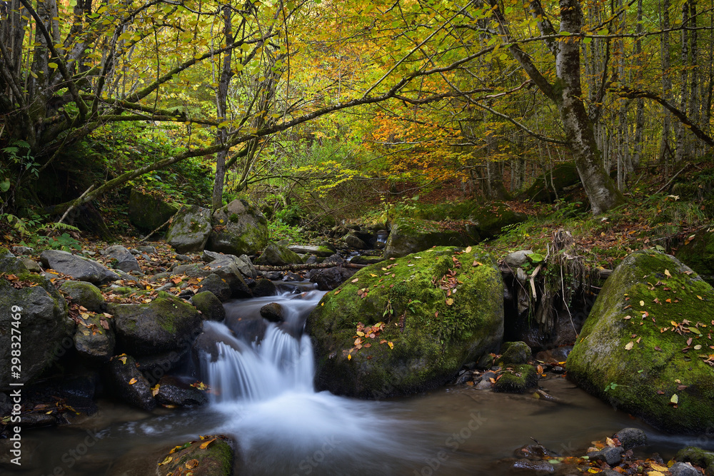 Waterfall in the mountains, autumn landscape in deep forest Waterfall in the mountains, autumn landscape in deep forest