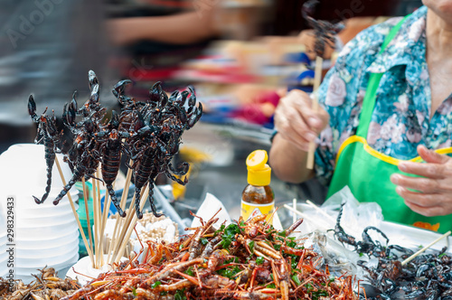 Deep fried scorpion skewers and insects, street food.