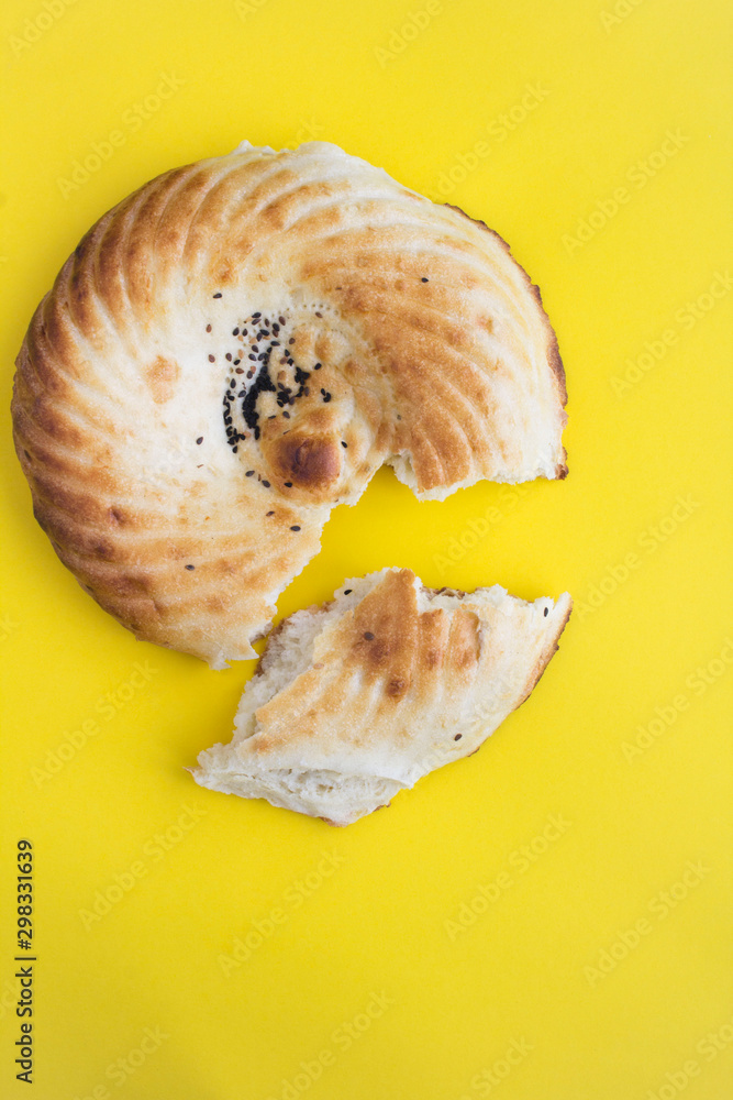 Homemade freshly baked bread on the yellow background. Top view. Copy space. Location vertical. Homemade freshly baked bread on the yellow background. Top view. Copy space. Location vertical.