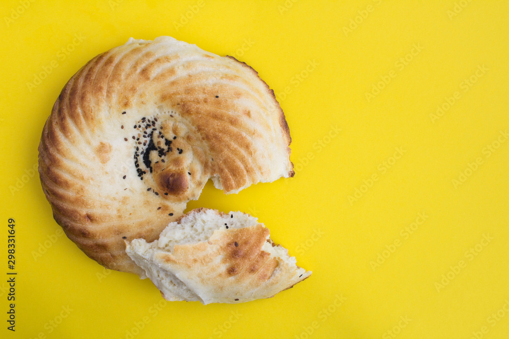 Homemade freshly baked bread on the yellow background. Top view. Copy space. Homemade freshly baked bread on the yellow background. Top view. Copy space.