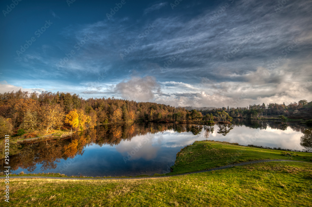 .Stunning landscape image of Tarn Hows in Lake District during beautiful Autumn Fall.