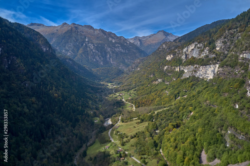 Autumn season  red-yellow trees. Aerial photography. Panoramic view of the Alps north of Italy. Trento Region. Great trip to the Alps.