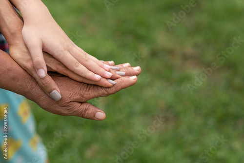 Close up of three asia person stack their palms. Grandmother mother and granddaughter holding their hands together. Gesture sign of support and love, unity togetherness relative people concept © sutlafk