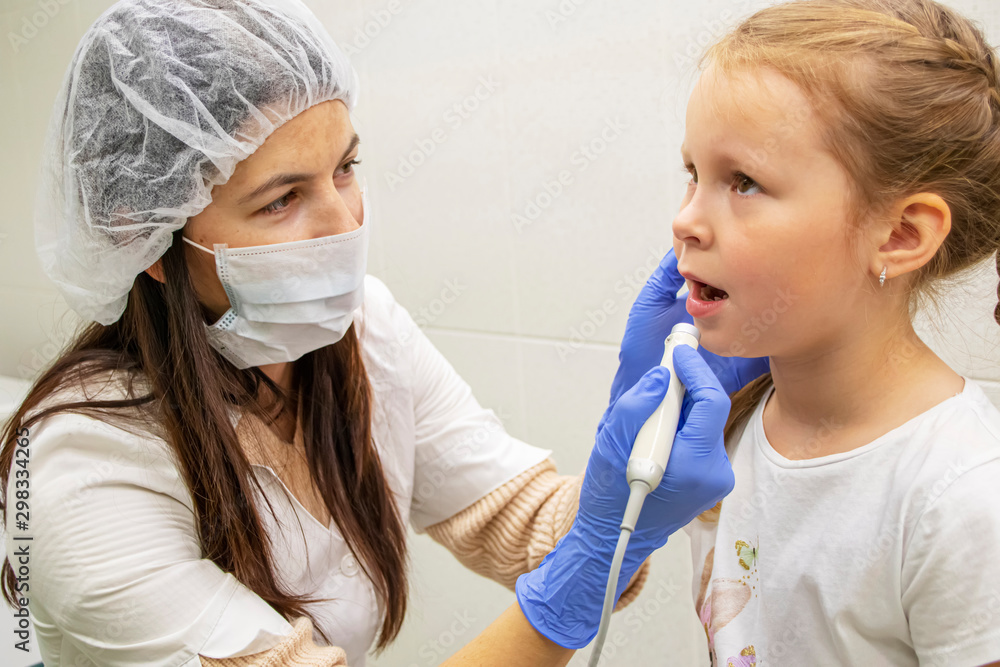 Dentist examines teeth of little Caucasian girl Dentist examines teeth of little Caucasian girl