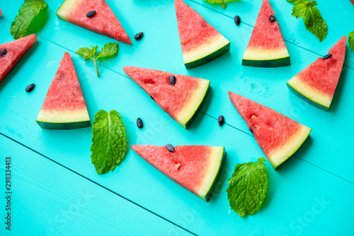 Watermelon slice with papermint on a blue rustic wood background